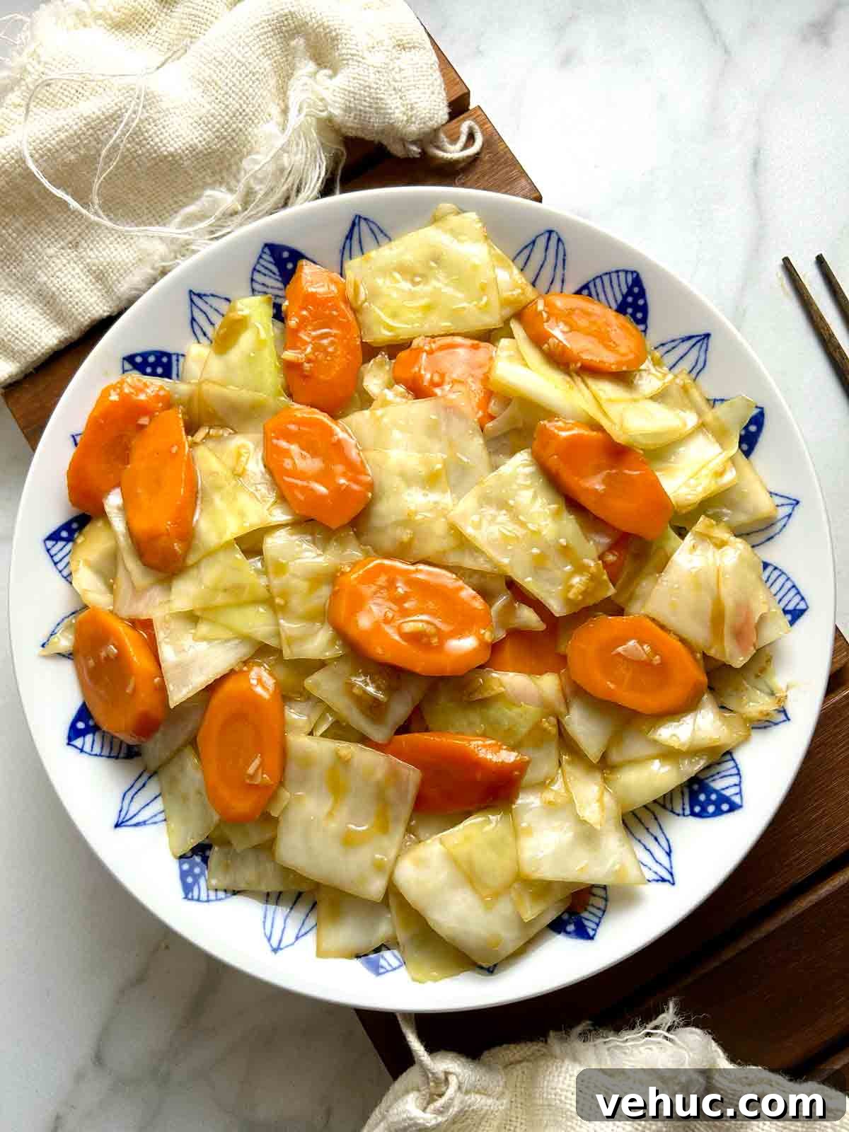overhead shot of carrots and cabbage stir-fry on plate.