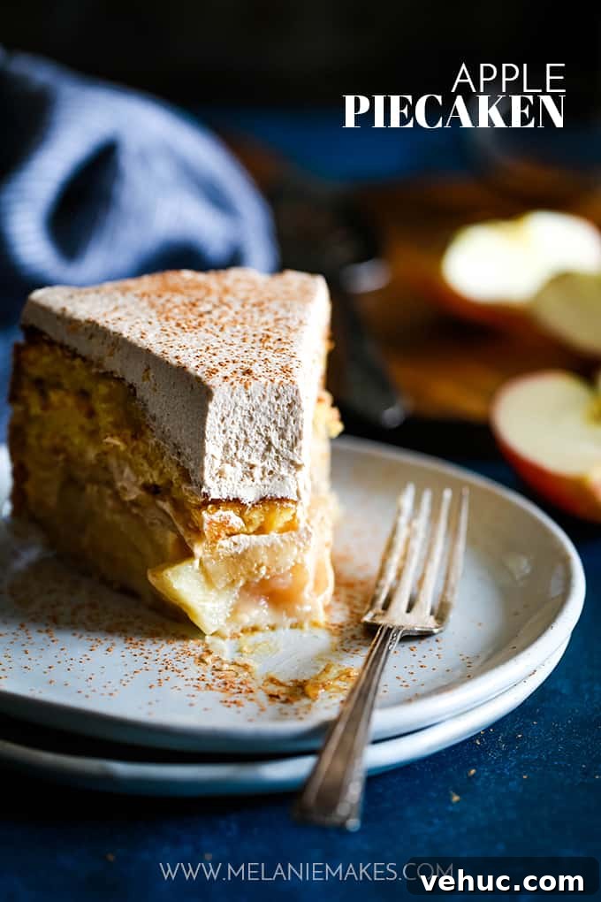 Apple Piecaken, you ask? I’ve baked an entire apple pie inside a yellow cake and frosted with my Cinnamon Cool Whip Frosting for a one of a kind dessert. #apple #applepie #cake #easydessert #easyrecipe A slice of Apple Piecaken with a bite removed sitting on a white plate with a fork.