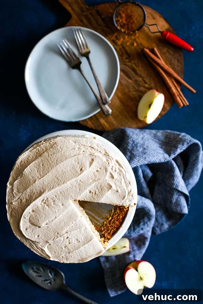 Apple Piecaken, you ask? I’ve baked an entire apple pie inside a yellow cake and frosted with my Cinnamon Cool Whip Frosting for a one of a kind dessert. An overhead view of an Apple Piecaken with a slice removed.