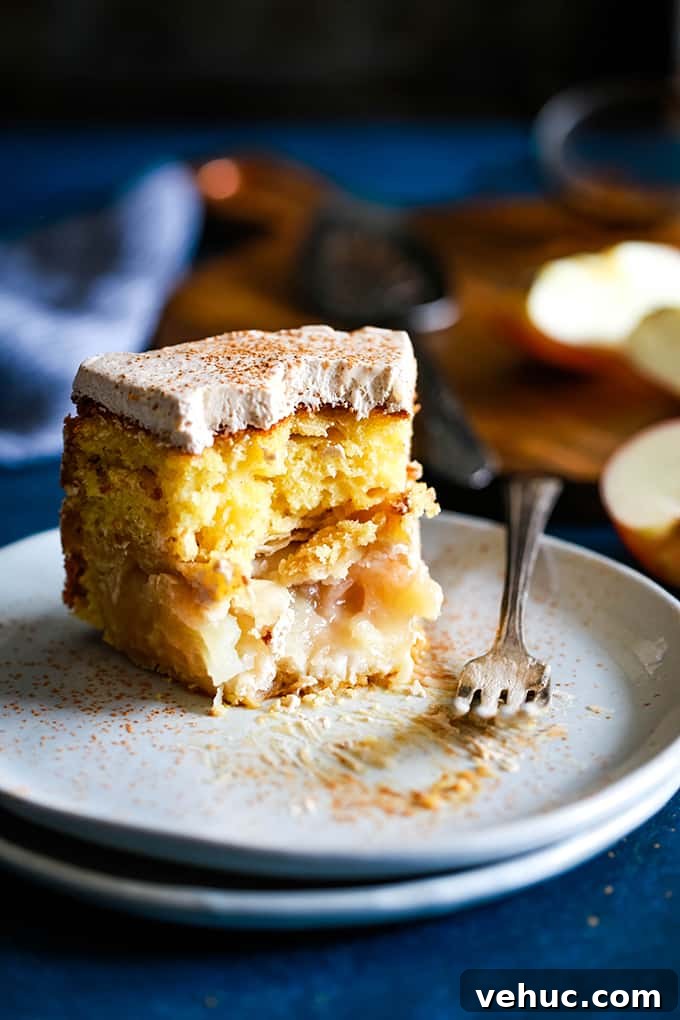 Apple Piecaken, you ask? I’ve baked an entire apple pie inside a yellow cake and frosted with my Cinnamon Cool Whip Frosting for a one of a kind dessert. A slice of Apple Piecaken with several bites removed resting on two white plates.