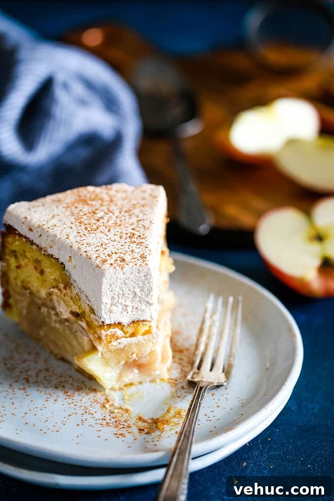 Apple Piecaken slice A slice of Apple Piecaken served on a white plate with a bite removed.