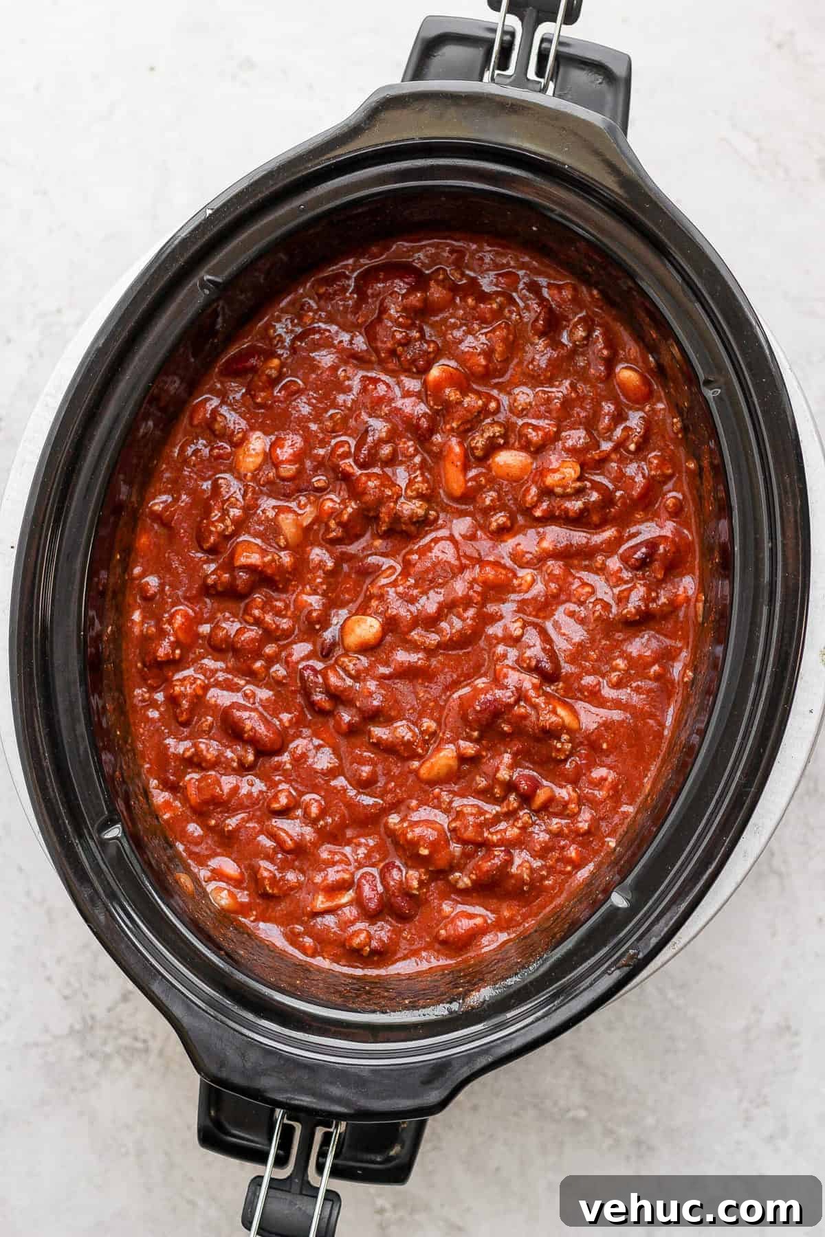 Slow cooker chili in a slow cooker looking delicious.