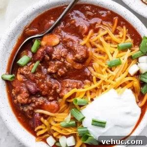 Slow cooker chili with sour cream and green onions.
