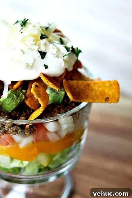 Layered Taco Salad with Seasoned Beef, Cheese, and Avocado 2 Layered Chopped Taco Salad from foodiewithfamily.com