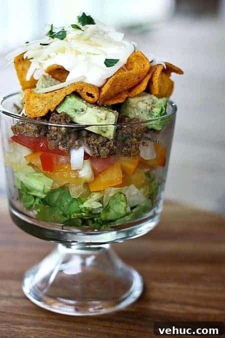 Layered Taco Salad with Seasoned Beef, Cheese, and Avocado 3 Layered Chopped Taco Salad from foodiewithfamily.com