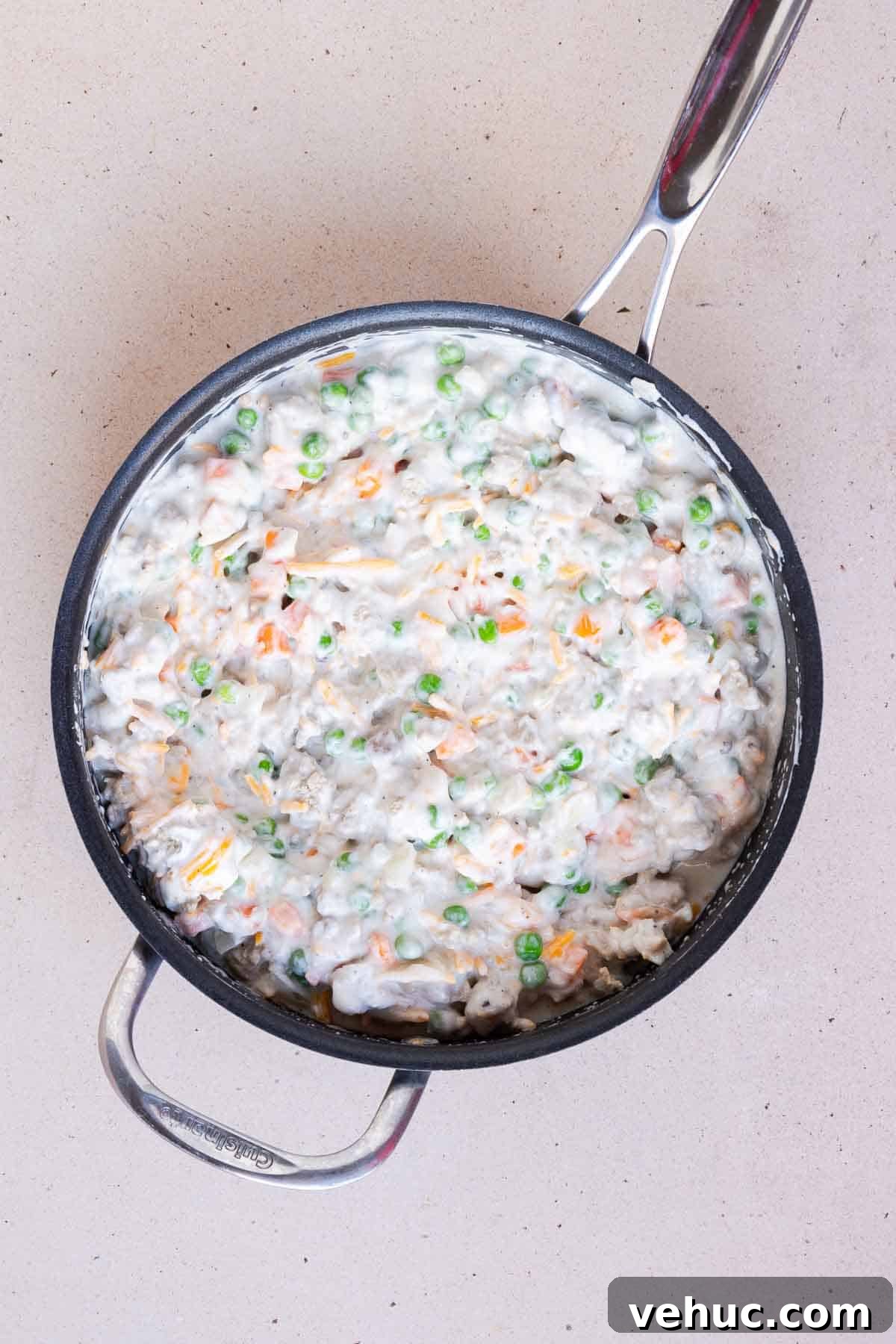 Cheesy Ground Turkey Tater Tot Casserole Recipe 5 The soup, Greek yogurt, cheese, milk, and frozen peas and carrots are mixed together with the turkey and onion mixture in the large skillet.