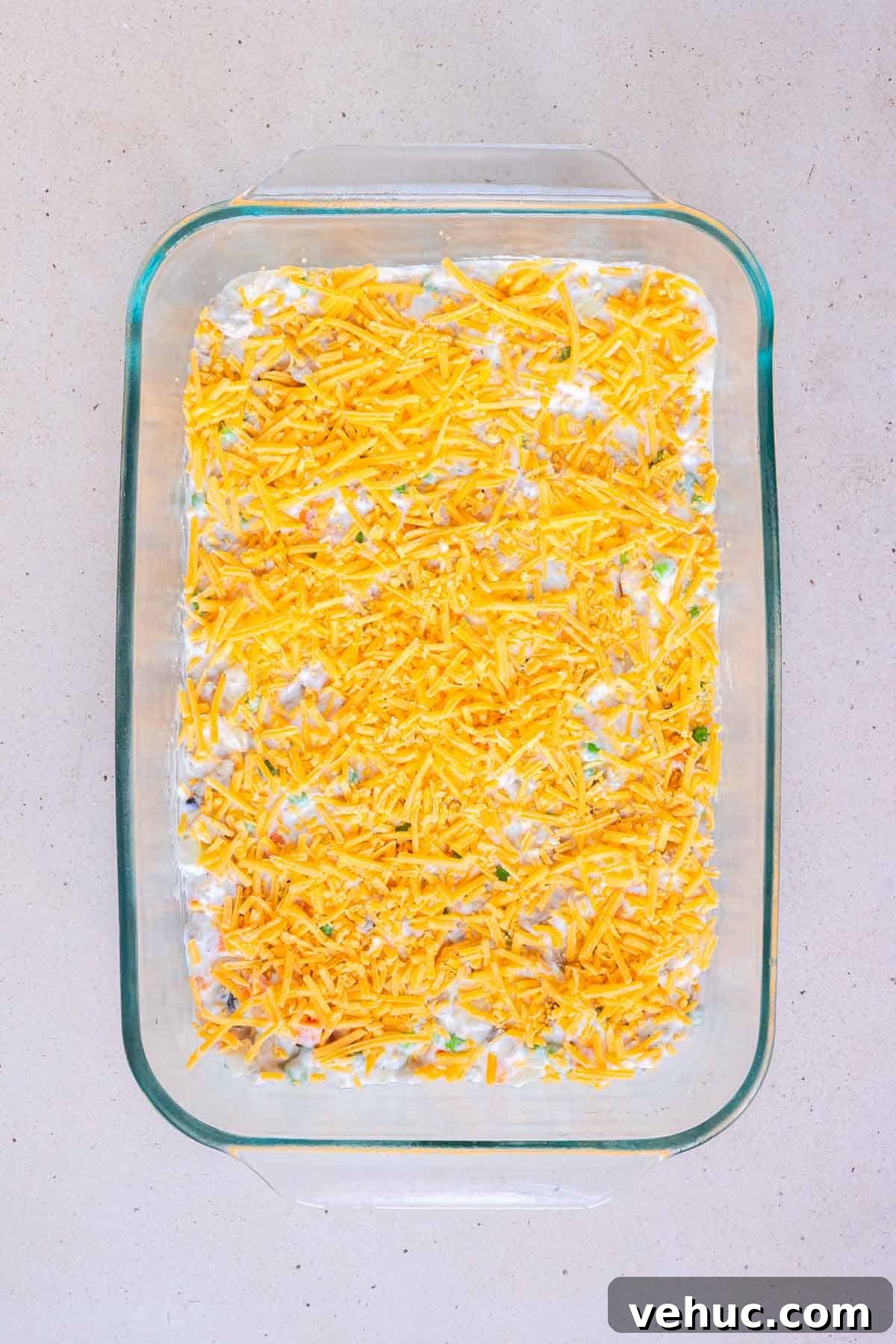 Cheesy Ground Turkey Tater Tot Casserole Recipe 7 The casserole filling is topped with an even layer of shredded cheddar.