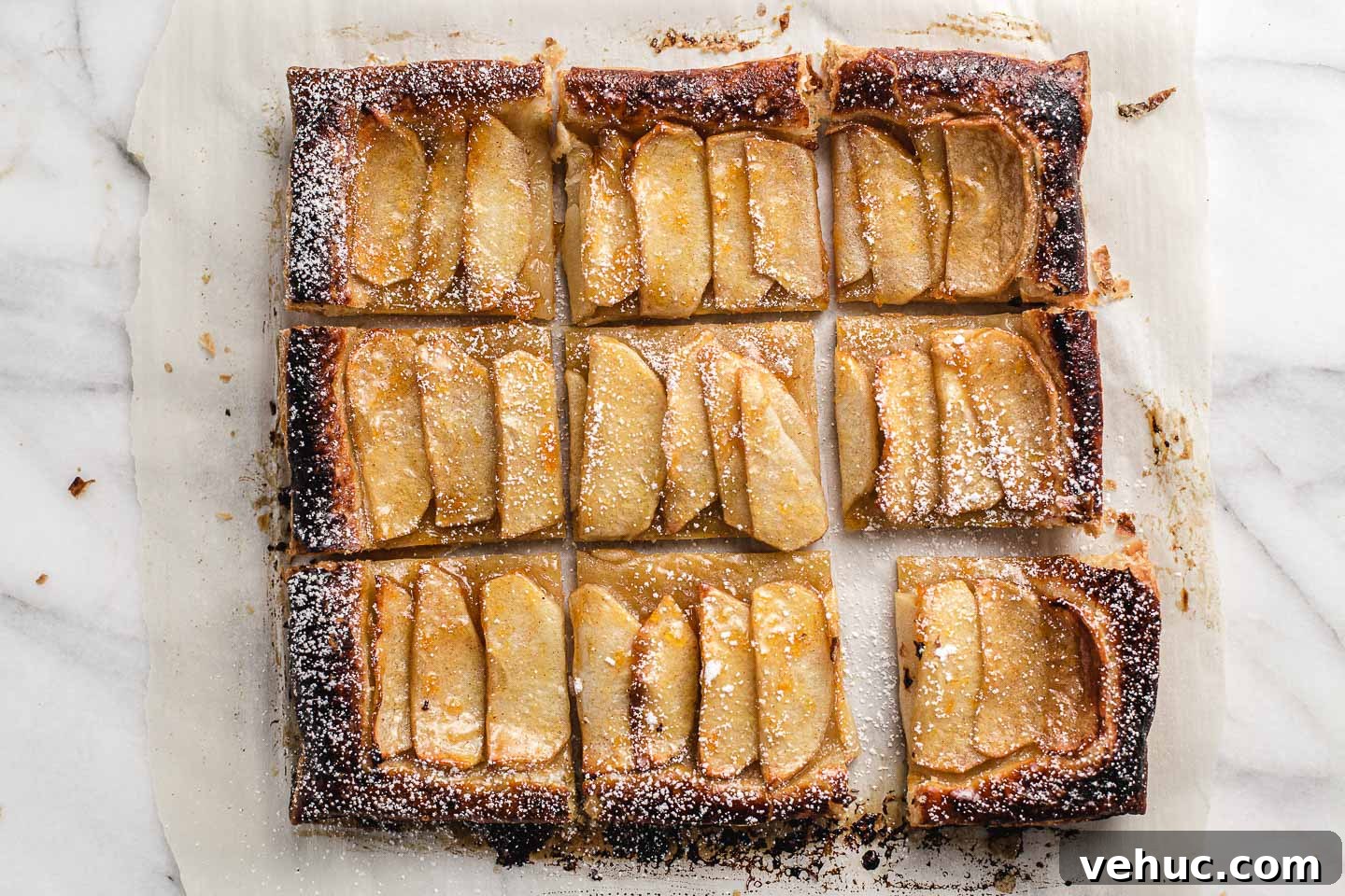 Rustic Apple Tart Recipe with Flaky Puff Pastry and Cinnamon 6 Apple tart cut into nine squares.