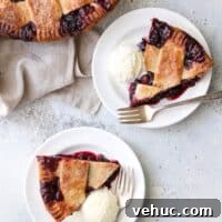 Cranberry Blueberry Pie Recipe with Flaky Homemade Crust 6 slices of cranberry blueberry pie on plates with vanilla ice cream