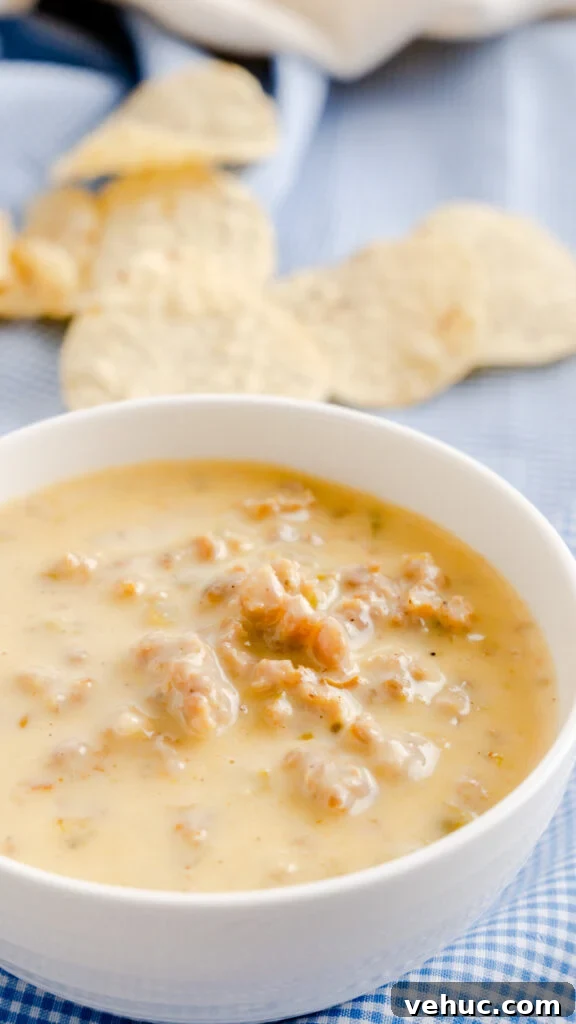 Sausage white queso dip made in the Instant Pot and served in white bowl. 