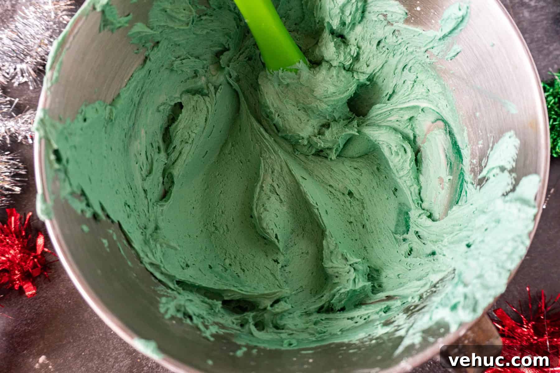 Christmas Tree Cookie Recipes: Festive Holiday Treat Ideas 11 Green Buttercream frosting in metal mixing bowl.