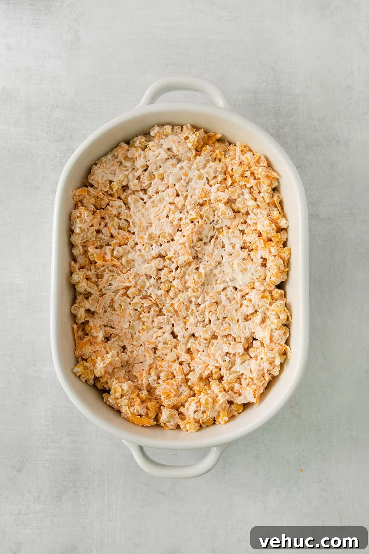 Creamy Cheddar Corn Casserole Recipe for Comforting Sides 5 a casserole dish filled with rice and meat.