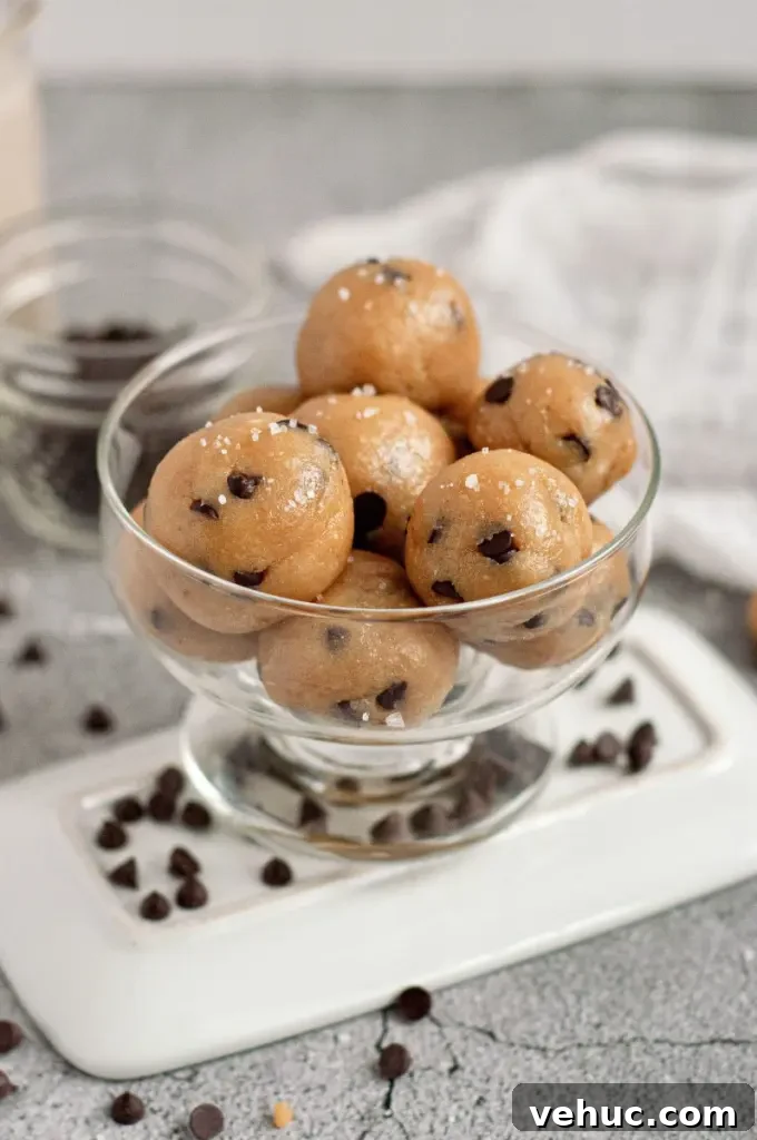 Golden brown cookie dough balls with dark chocolate chips sprinkled with sea salt.