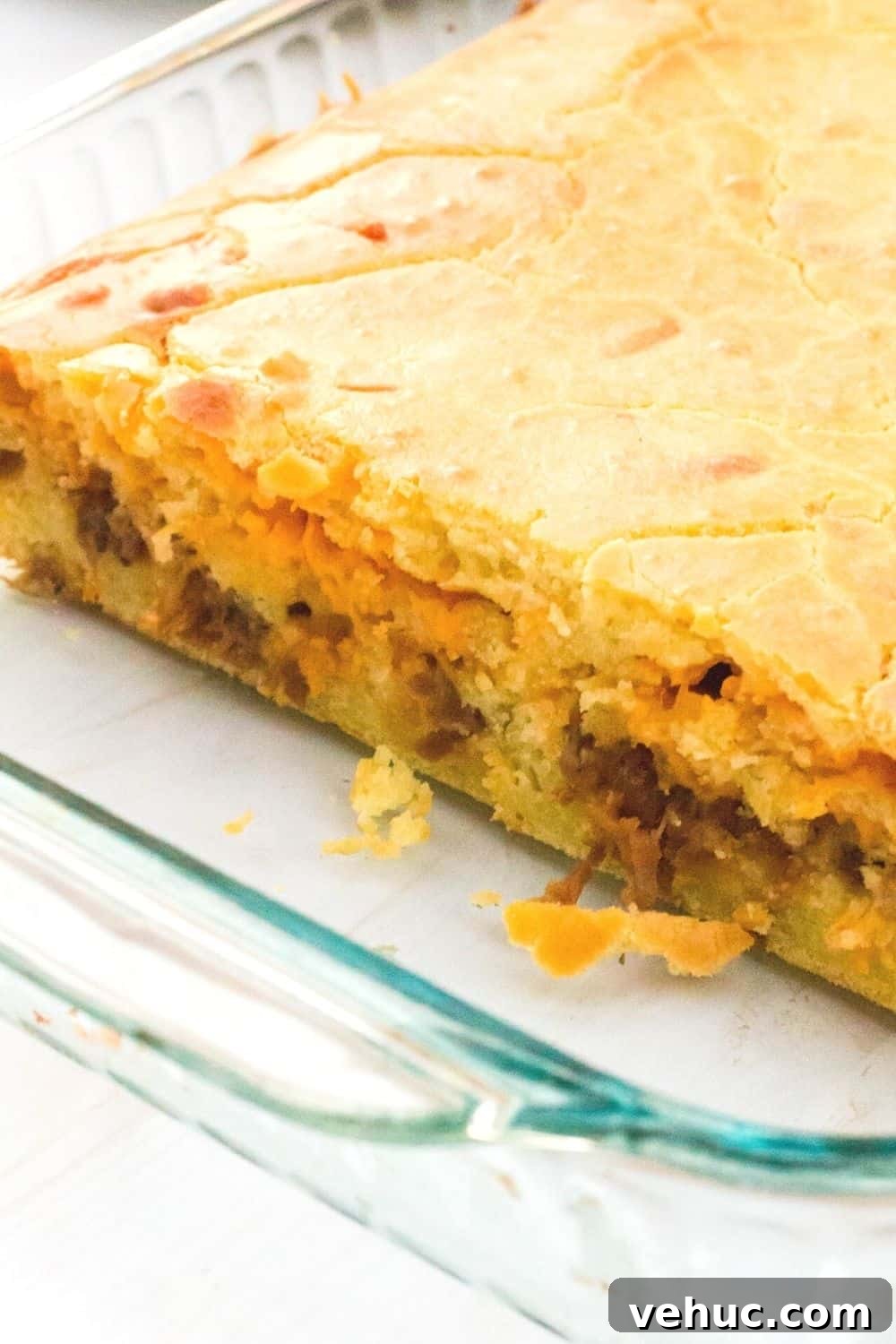 Bola de Carne Portuguese Meatloaf Recipe — Authentic & Flavorful 3 a glass Pyrex pan with freshly baked bola de carne, a Portuguese recipe using bread, meat, and cheese.