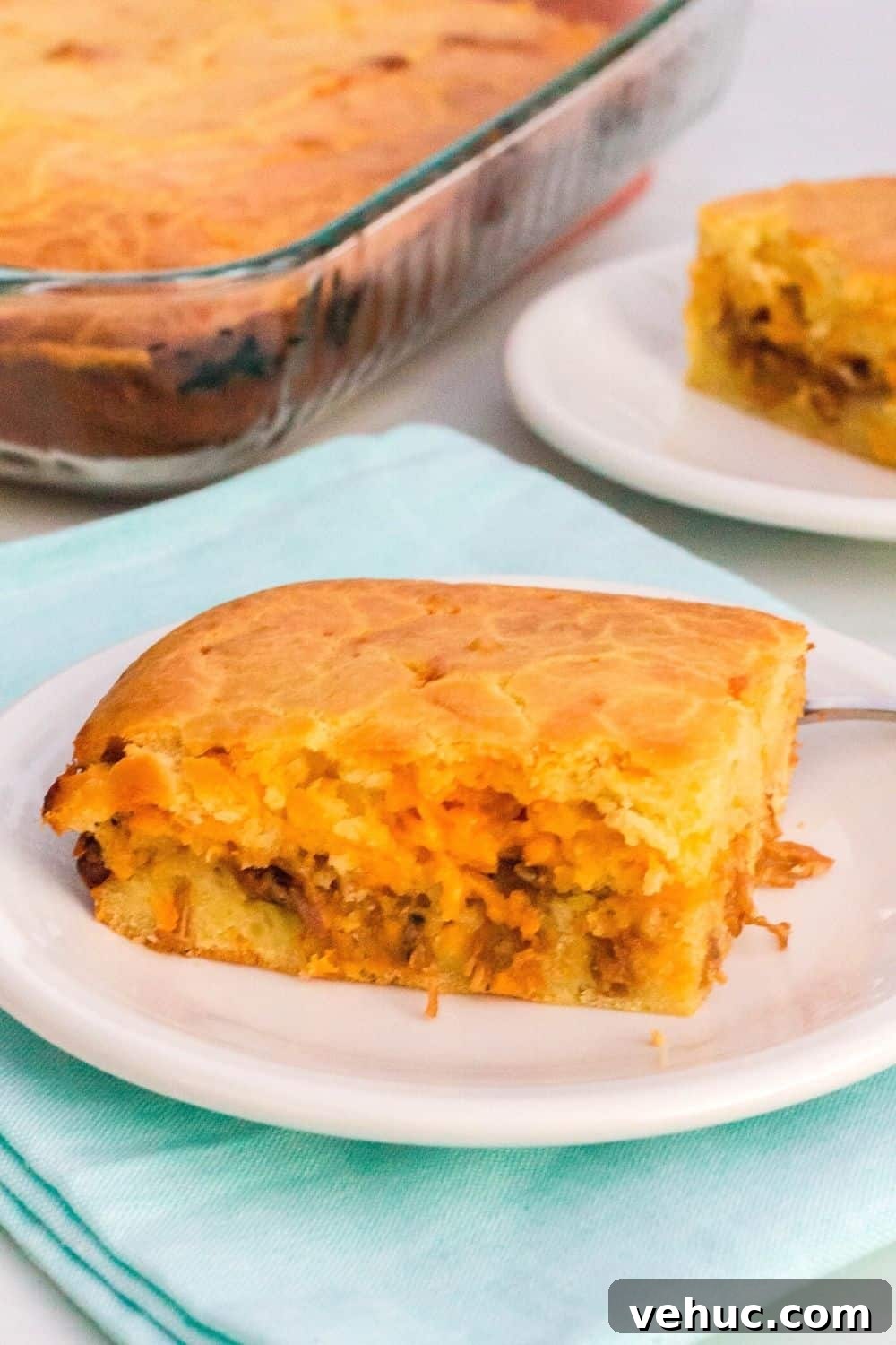 Bola de Carne Portuguese Meatloaf Recipe — Authentic & Flavorful 10 slice of portuguese meat bread on a white plate, resting on a light blue napkin