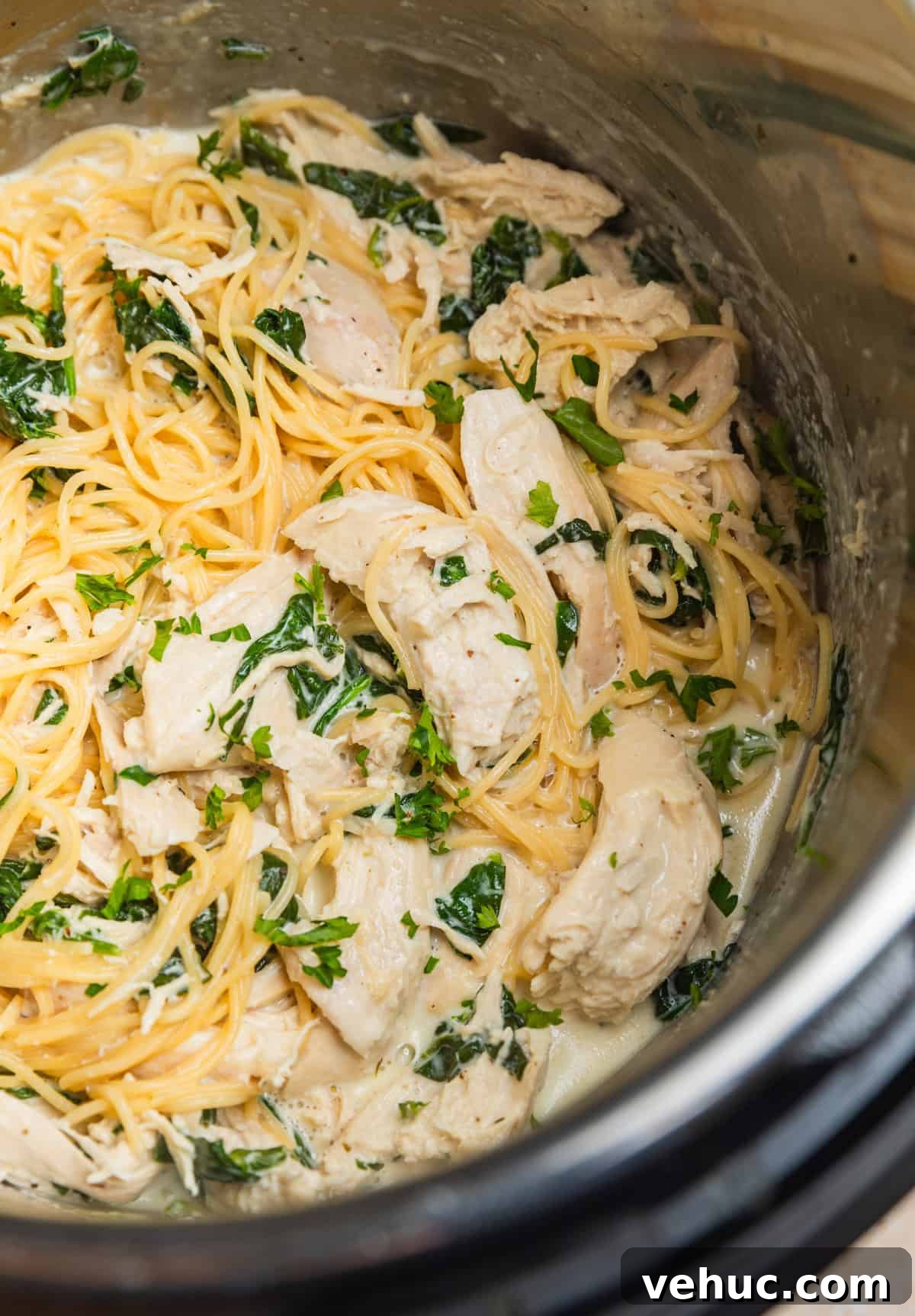 Creamy Parmesan Chicken in the Instant Pot: Quick Weeknight Meal 3 Instant pot with pasta and creamy chicken and spinach.