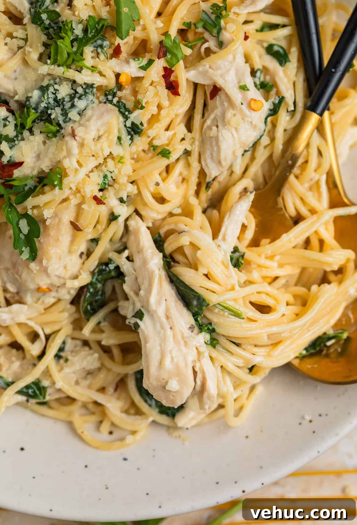 Creamy Parmesan Chicken in the Instant Pot: Quick Weeknight Meal 8 Forkful of pasts with creamy chicken and spinach on plate.