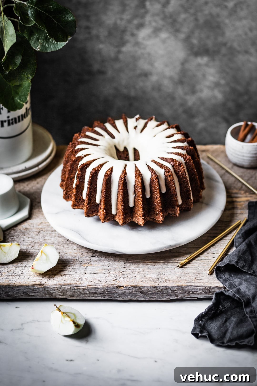 Moist Applesauce Bundt Cake Recipe for Fall Baking 2 Apple bundt cake with white glaze on a marble platter