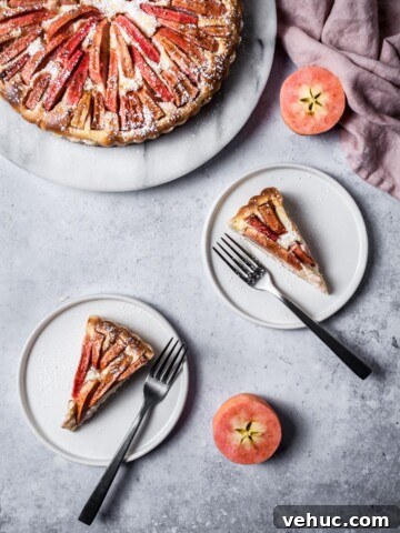 Two slices of pink apple tart on white plates