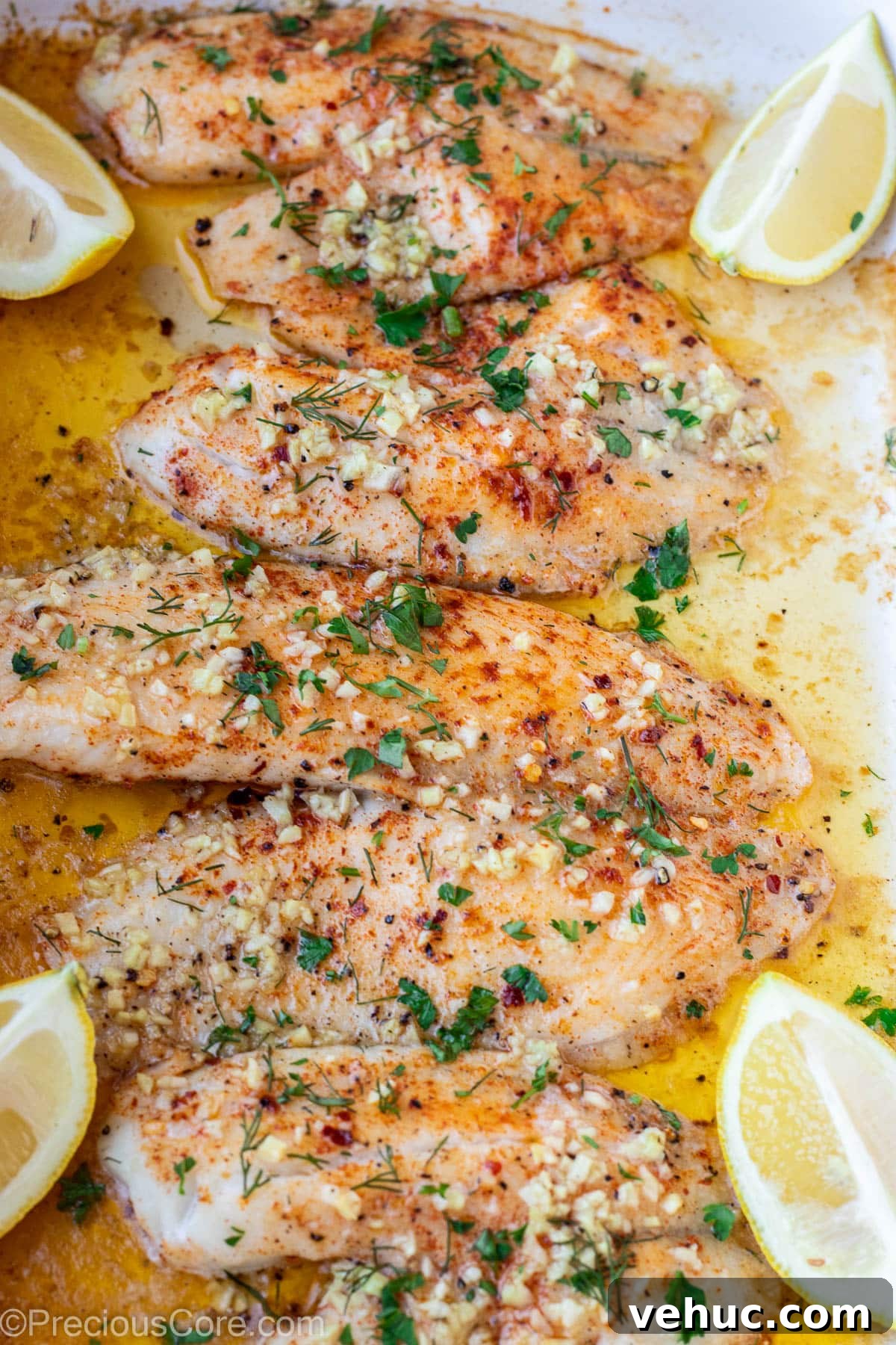 Garlic Butter Tilapia Recipe with Lemon and Herbs 2 4 baked tilapia fillets in a pan.