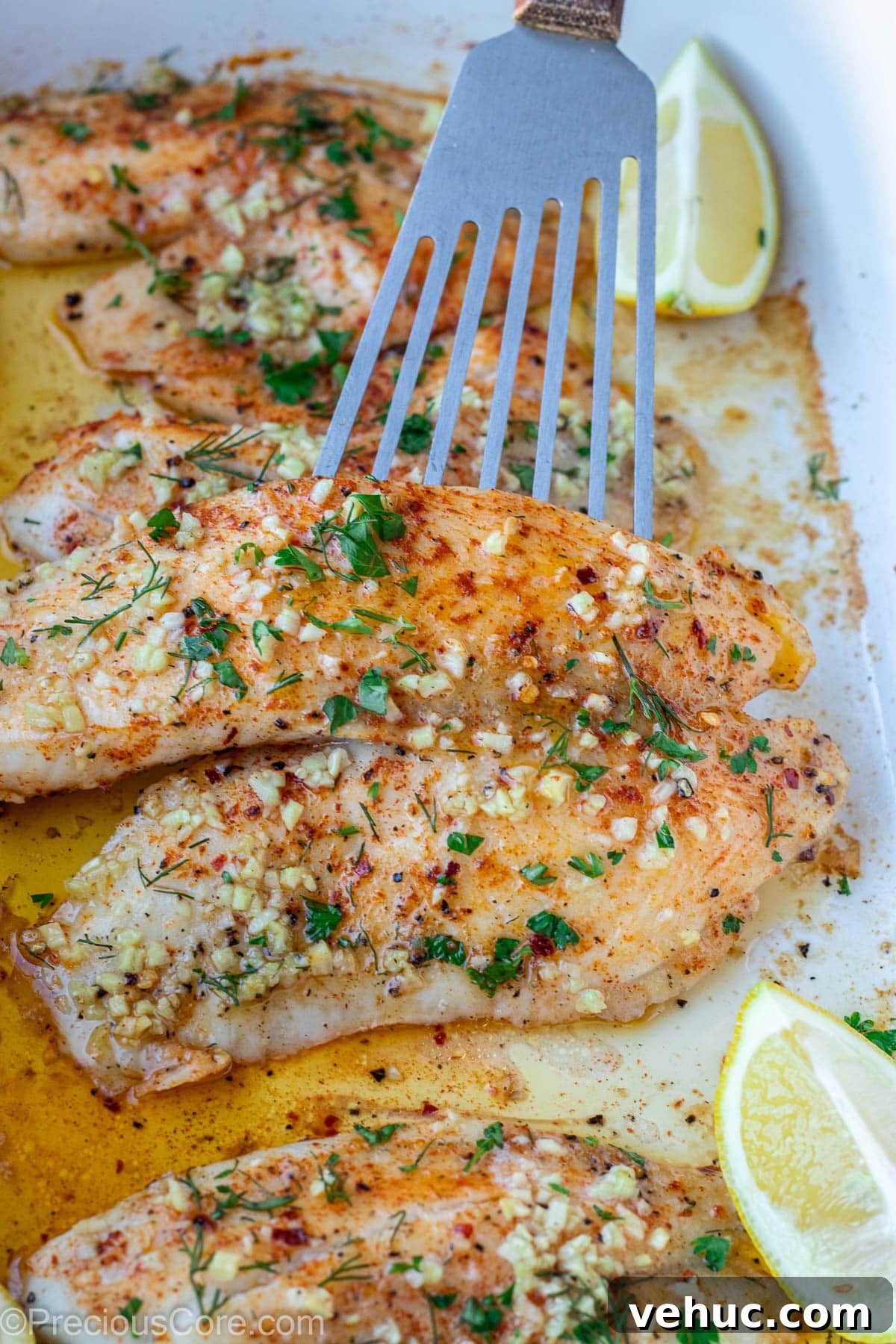 Garlic Butter Tilapia Recipe with Lemon and Herbs 4 Tilapia fillet with garlic butter on top.