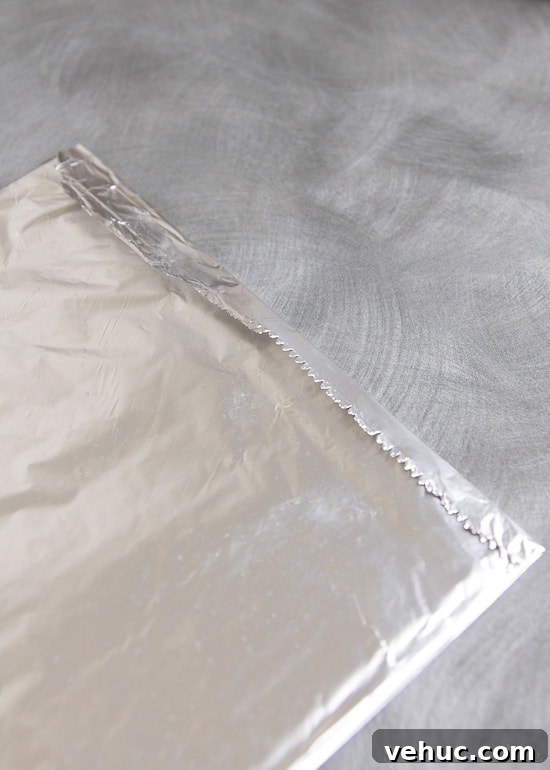 DIY Cake Strips: How to Wrap, Use, and Bake Even Layers 9 The edge of the foil folded over the paper towels.