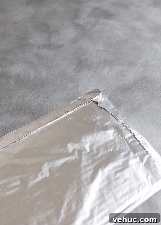 DIY Cake Strips: How to Wrap, Use, and Bake Even Layers 10 The long edge of the foil folded over to enclose the paper towels completely.