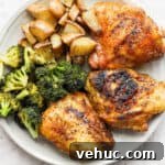 Plate of smoked chicken thighs, broccoli and potatoes.