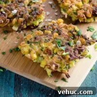 Crispy Zucchini and Sweet Corn Fritters Recipe 6 zucchini and corn fritters with a lemon wedge and sour cream