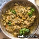 Pesto Chicken with Roasted Artichokes Recipe 11 Skillet filled with creamy pesto artichoke chicken served with Parmesan and fresh basil leaves.