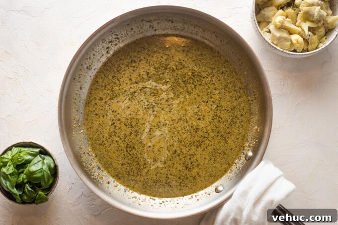 Pesto Chicken with Roasted Artichokes Recipe 5 Pesto cream sauce in a skillet.