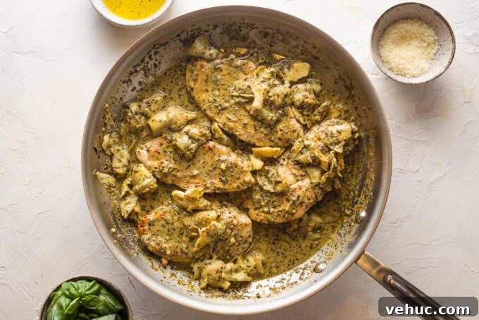 Pesto Chicken with Roasted Artichokes Recipe 7 Chicken breasts returned to the skillet with pesto cream sauce and artichokes spooned on top.