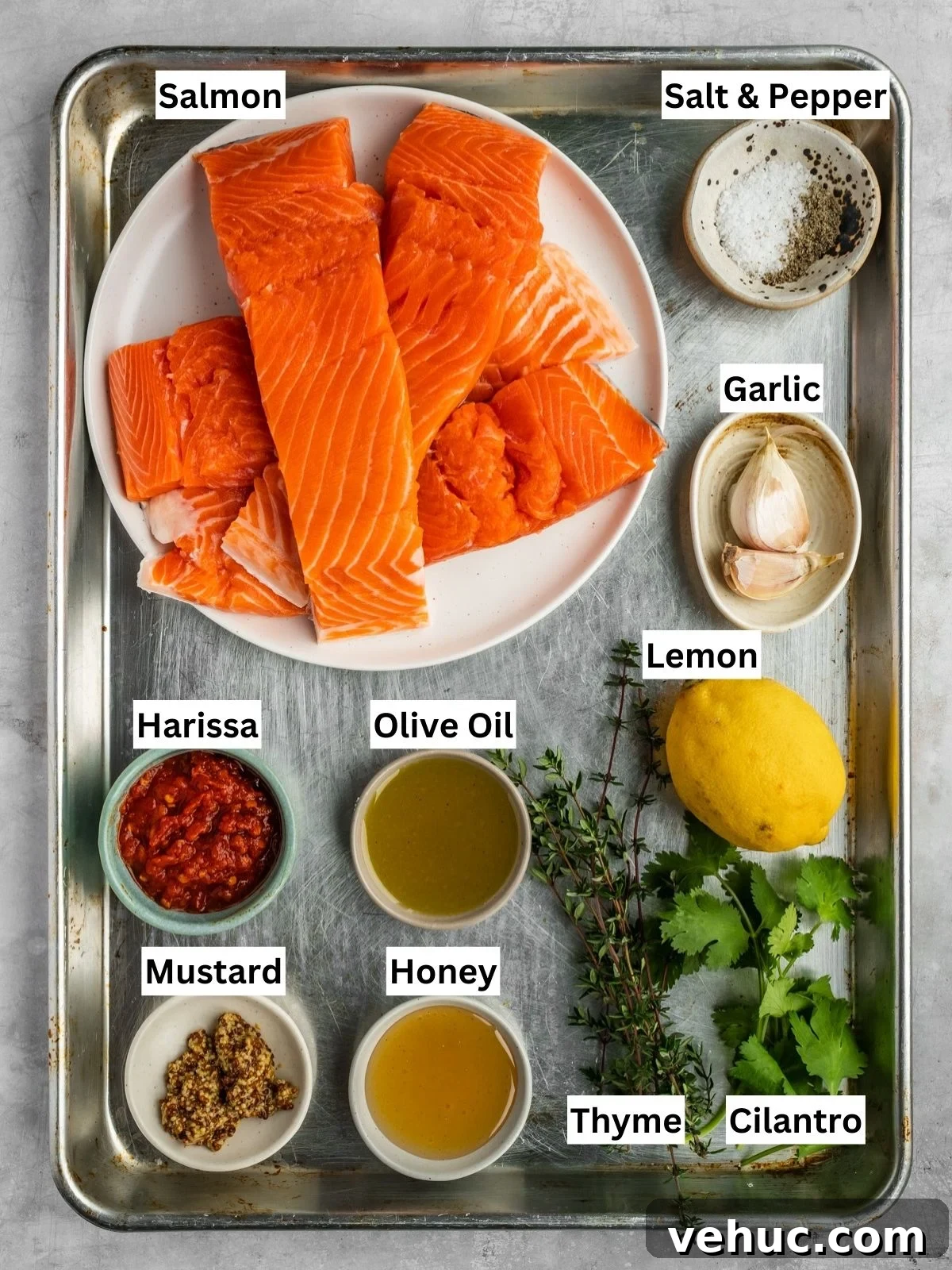 Honey Harissa Salmon with Garlic, Thyme & Lemon Roast 4 Honey Harissa Salmon Recipe ingredients with individual labels on a metal tray.