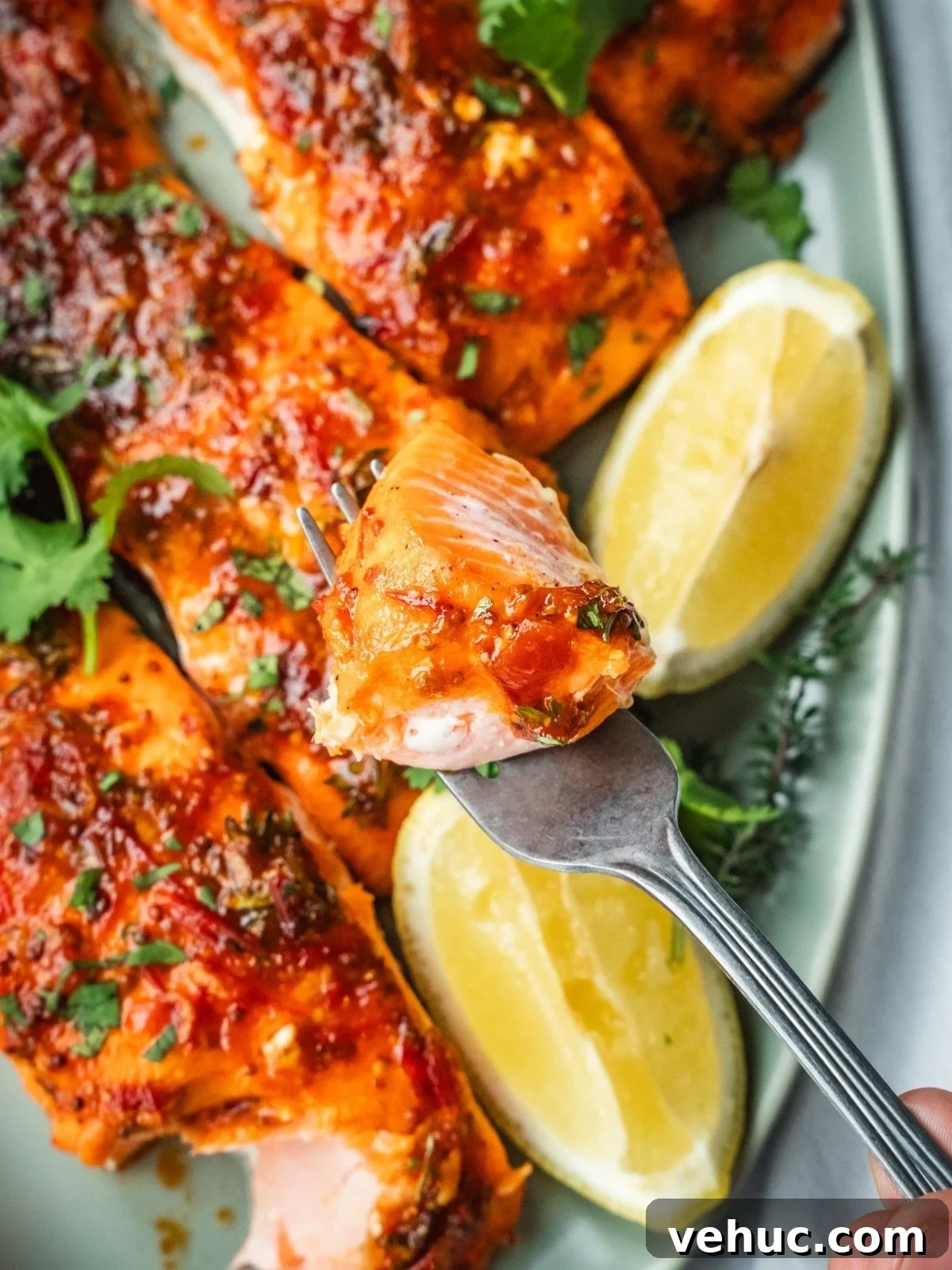 Honey Harissa Salmon with Garlic, Thyme & Lemon Roast 9 A fork with a piece of Honey Harissa Salmon.