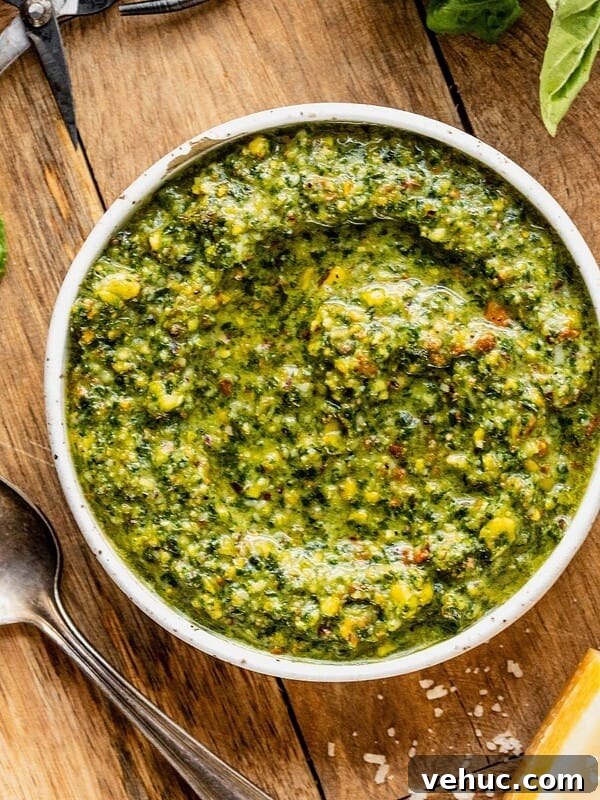 Bowl of pistachio pesto on a wooden tray.