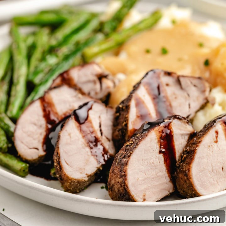 Glazed Teriyaki Pork Tenderloin Recipe with Garlic and Ginger 5 Close up view of balsamic pork tenderloin on a plate.