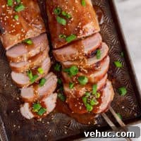 Glazed Teriyaki Pork Tenderloin Recipe with Garlic and Ginger 6 Top down view of a serving fork with teriyaki pork tenderloin.