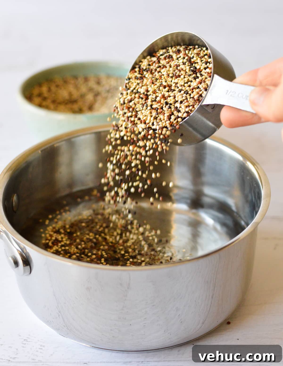 How to Cook Tri-Color Quinoa Perfectly Every Time 4 pouring tri color quinoa into a saucepan.
