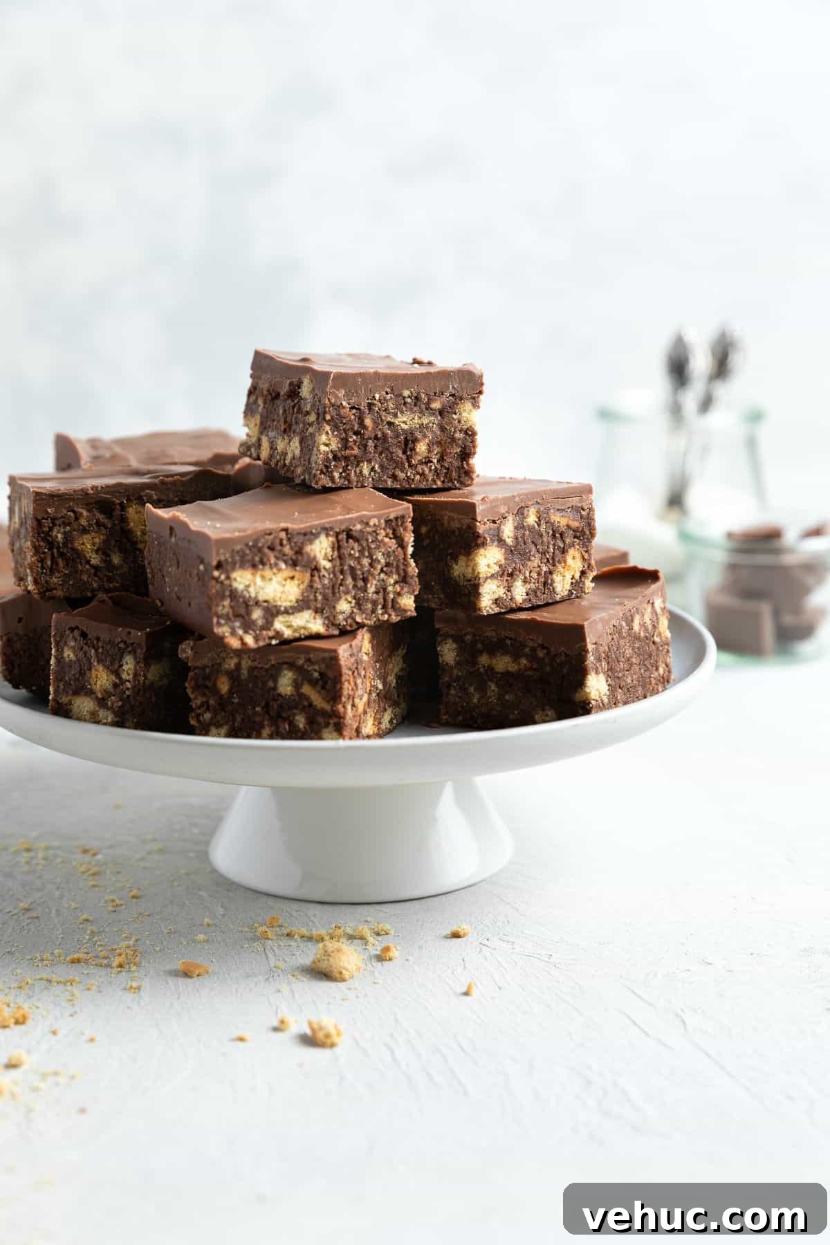 No-Bake Chocolate Hedgehog Slice Recipe: Quick Crowd-Pleaser 2 Cut pieces of slice, sitting on a round white cake stand.