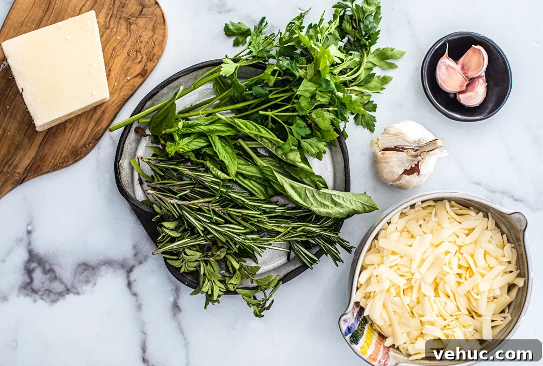 Herb & Garlic Cheese Pizza Recipe for Crispy, Flavorful Homemade Slices 3 Overhead shot of ingredients: fresh herbs, parmesan cheese, shredded mozzarella in a bowl, and garlic cloves.