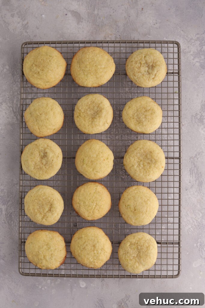 A batch of lime cookies on a baking rack.