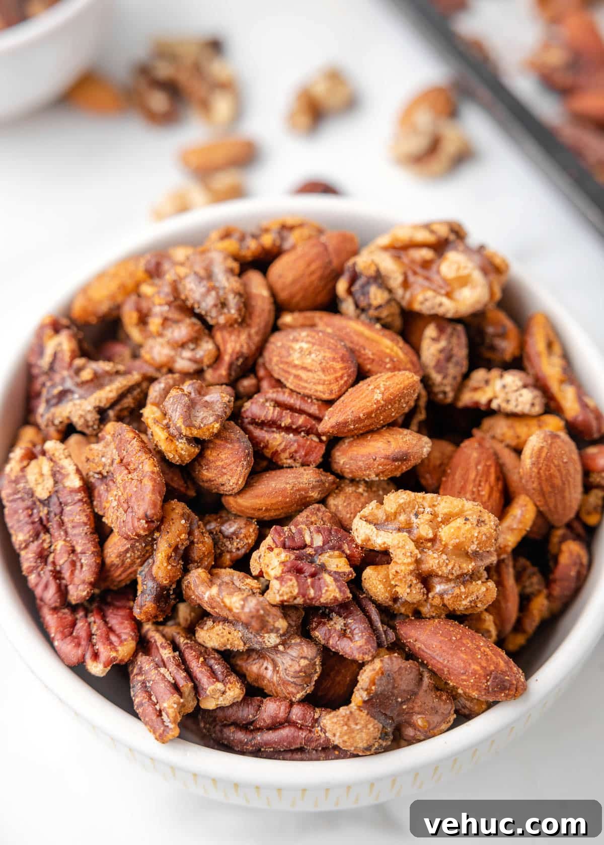 Cajun-Spiced Mixed Nuts: Bold and Flavorful Snack Recipe 6 cajun spiced nut mix in a white bowl on a marble board
