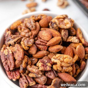 Cajun-Spiced Mixed Nuts: Bold and Flavorful Snack Recipe 7 cajun spiced nut mix in a white bowl on a marble board