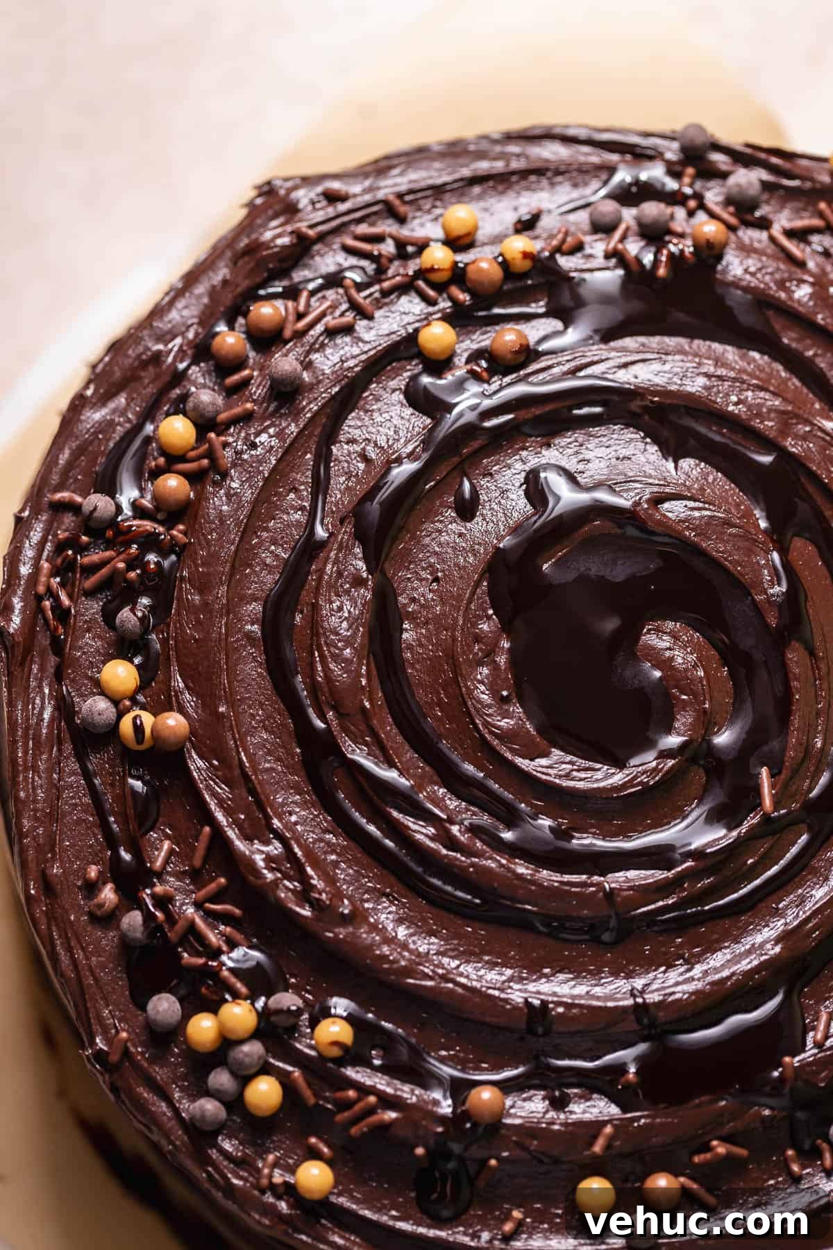 Moist Chocolate Cake Recipe That Tops Bakery Cakes 8 Top view of a chocolate cake with swirled chocolate frosting and chocolate sprinkles