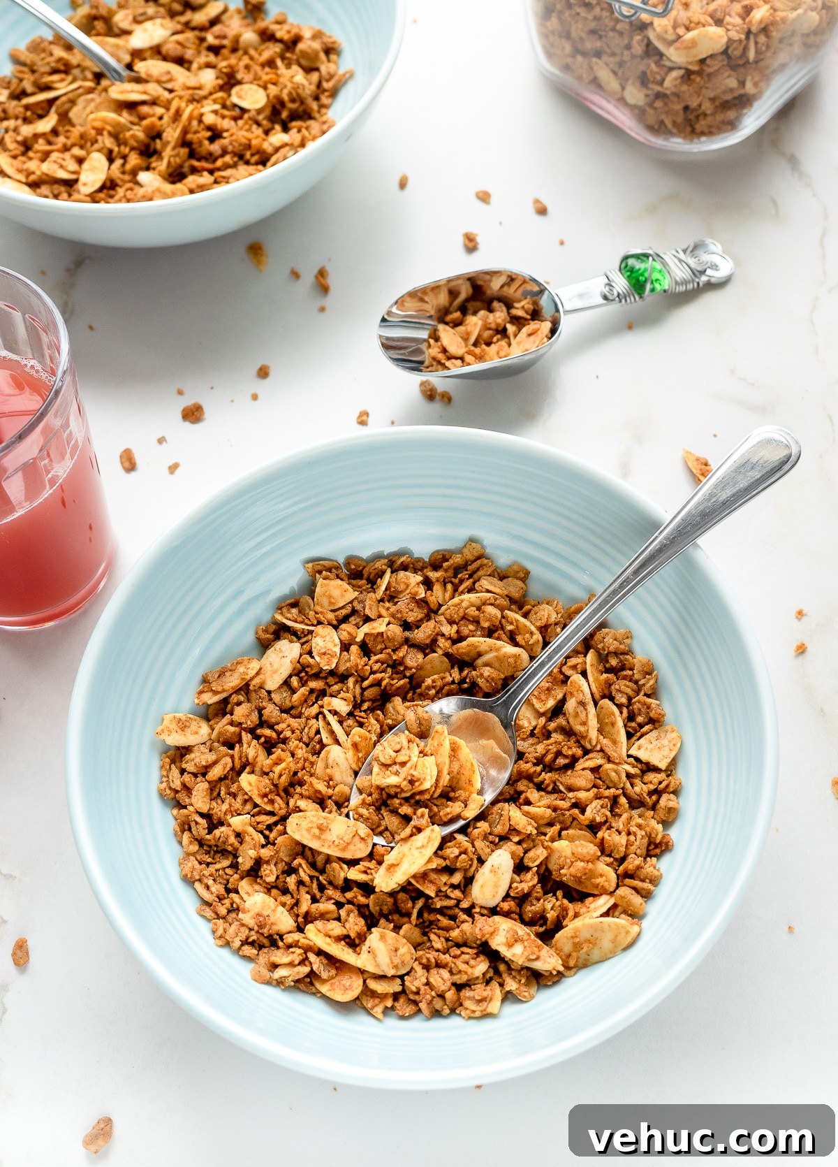 Crunchy Vanilla Almond Granola Recipe for Homemade Mornings 3 Homemade vanilla almond granola in a bowl with glass of juice next to it.