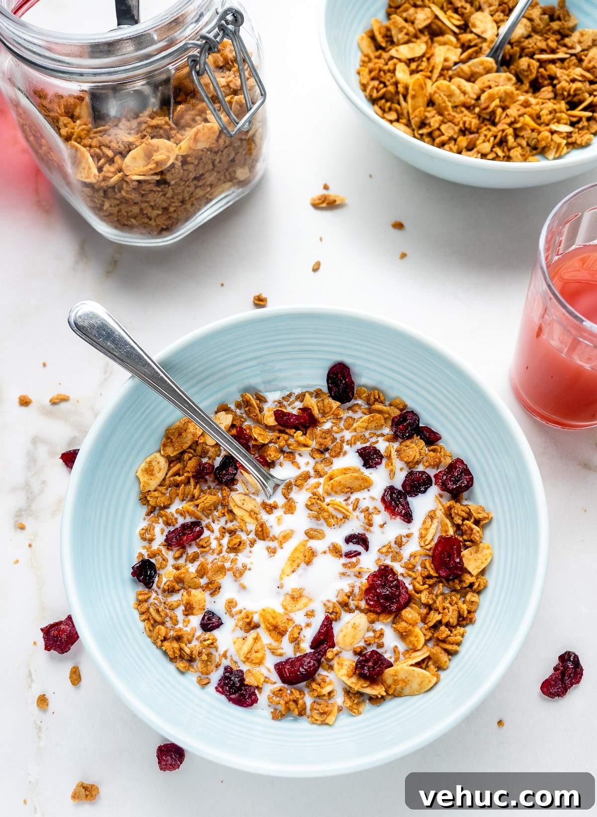 Crunchy Vanilla Almond Granola Recipe for Homemade Mornings 8 Bowl of French vanilla almond granola with milk and a glass of juice next to it.