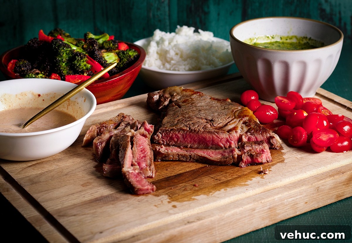 Garlic Aioli Steak & Rice Bowls with Fresh Chimichurri 4 All the ingredients you need to make steak and rice bowls: reverse seared steak, garlic aioli, chimichurri sauce, cooked rice, roasted vegetables, and cut cherry tomatoes.