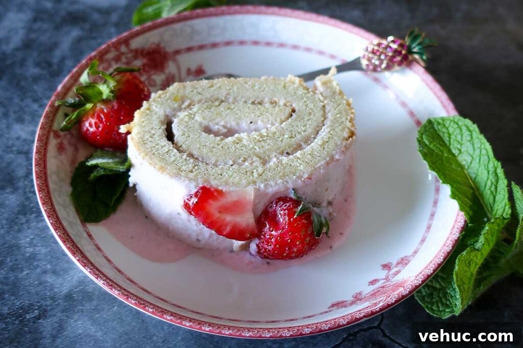 a slice of strawberry jelly roll on a dessert plate