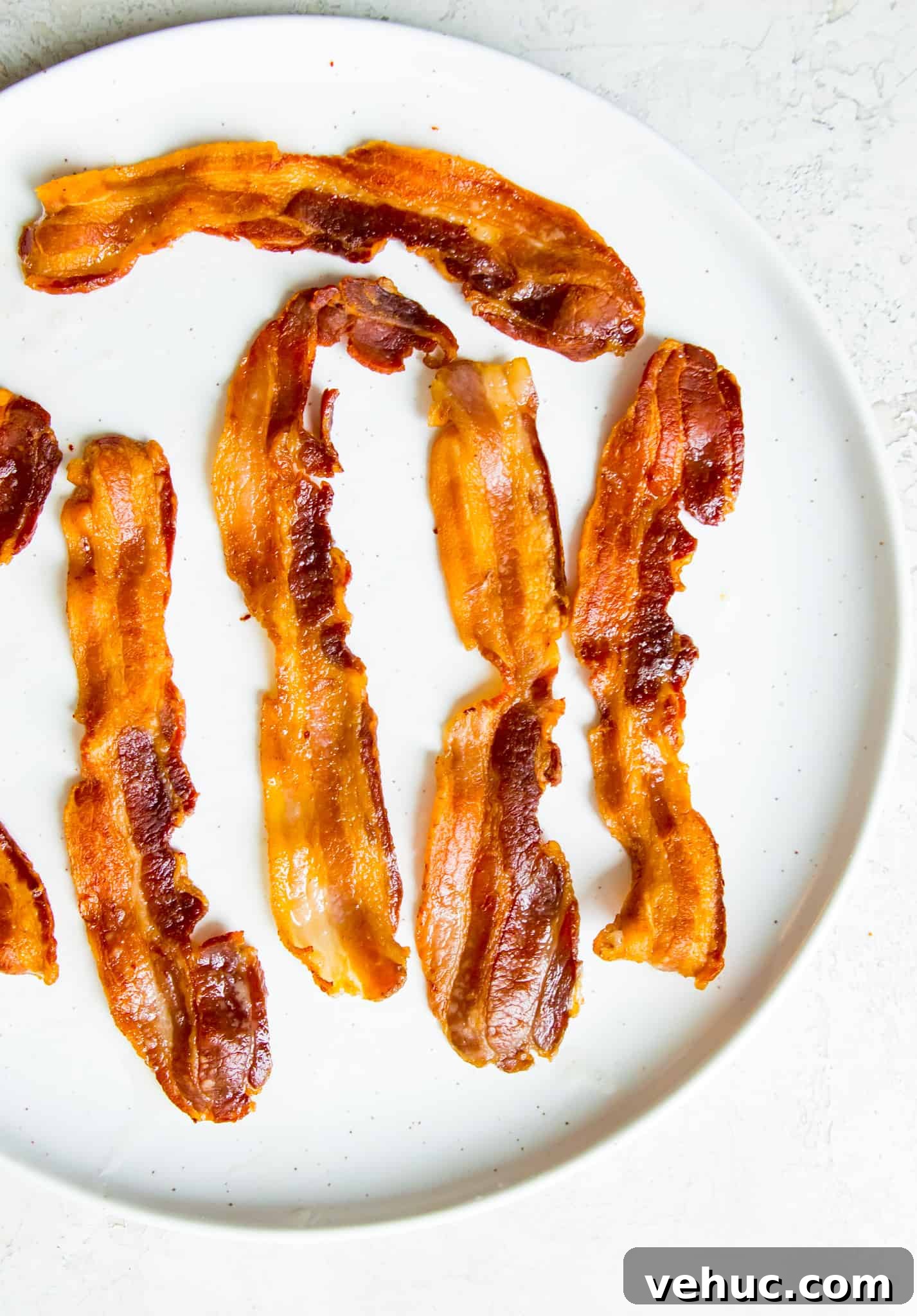 Instant pot cooked bacon Strips of cooked bacon on a plate.