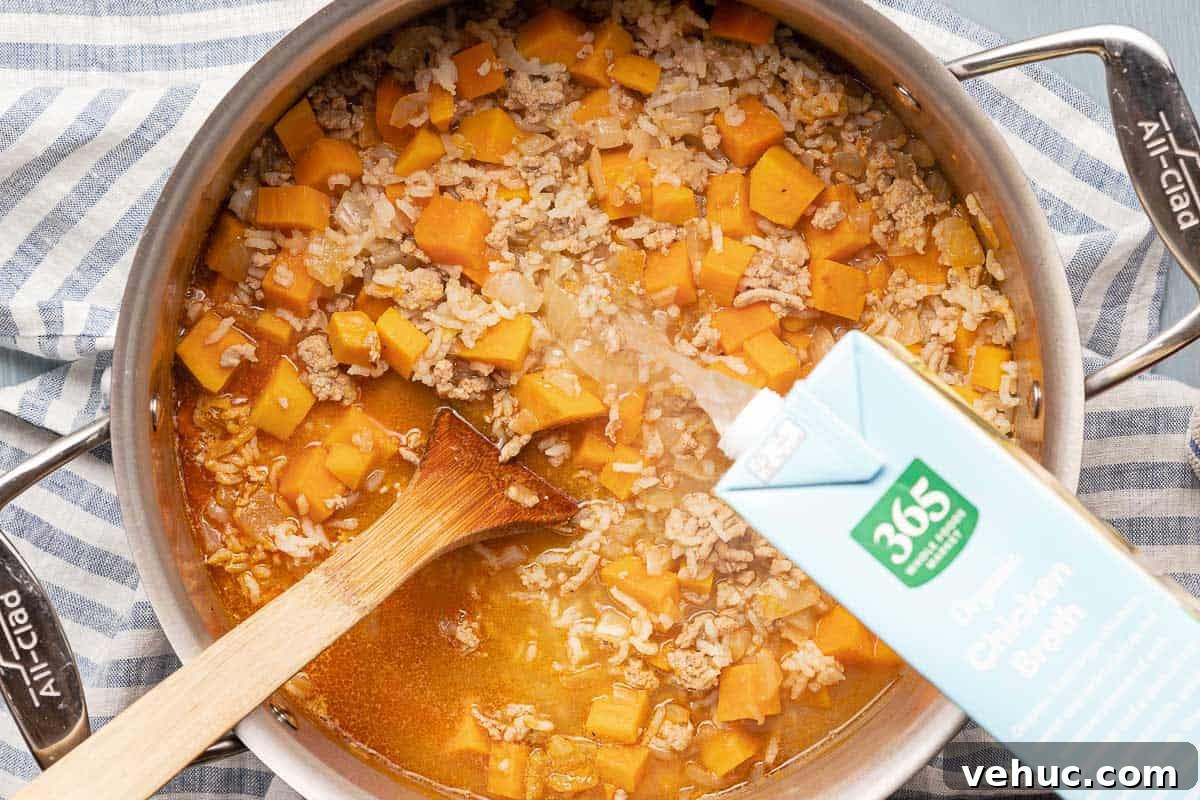Roasted Turkey and Sweet Potato Soup Recipe 12 chicken broth being poured into cooked soup